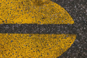 Yellow paint road marking on asphalt highway surface,...