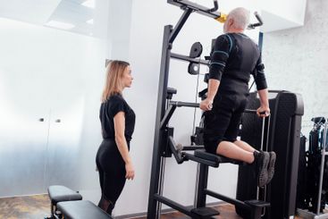 Elderly greyhaired man in ems suit is engaged on the...