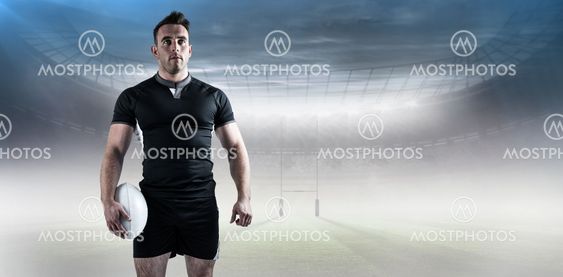 Composite image of tough rugby player holding ball