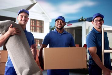 Professional movers efficiently unload furniture and carpet