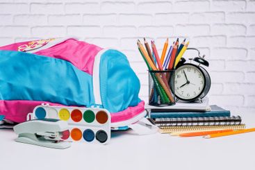 Colorful school supplies arranged neatly on a table with...
