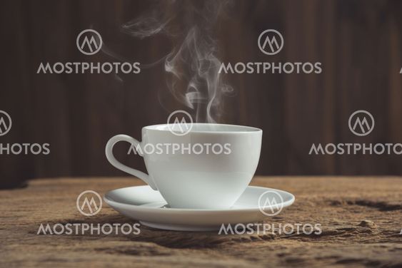 white coffee cup with smoke on wooden table