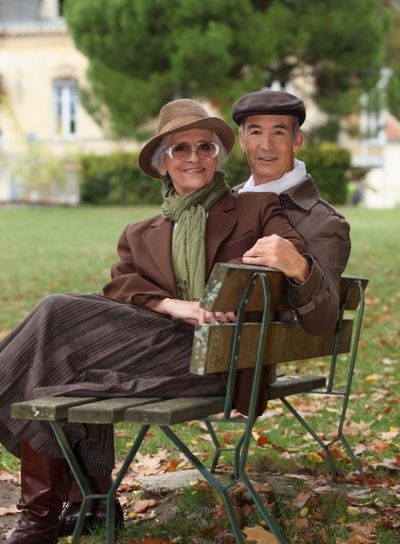 Elderly couple sat on bench