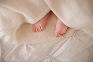Baby, feet and toes or blanket on bed for childhood...