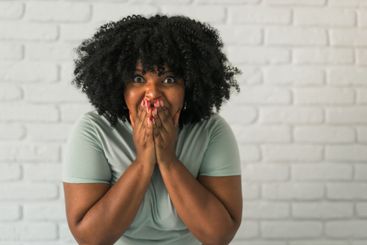 African American woman expressing pure joy with an...