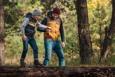 father and son walking in forest
