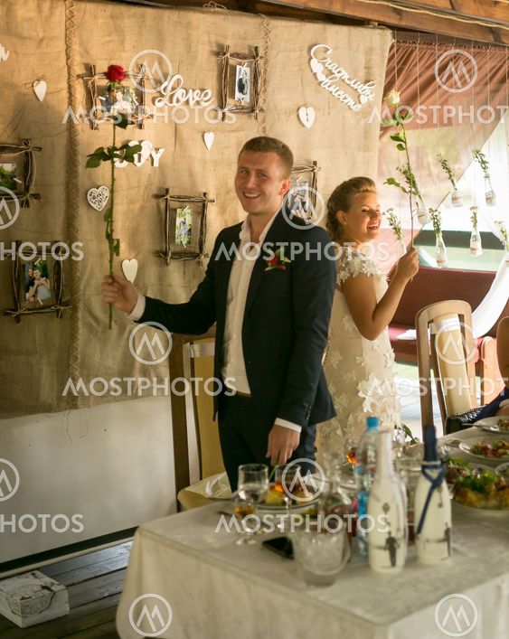Toned shot of happy smiling bride and groom posing at...