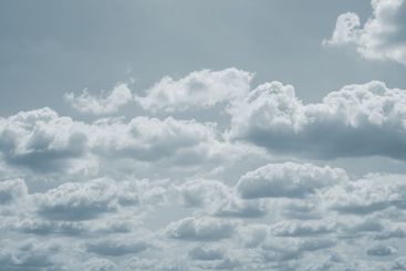 Dramatic overcast sky with gray clouds forming moody and...