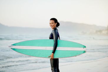 Portrait, surfboard or happy woman at sea for fitness...