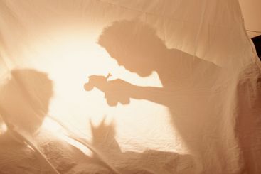Shadow, parent and child with toys for playing,...