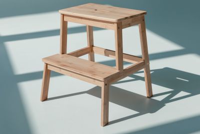 simple wooden flower stand at empty room with daylight