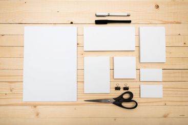 Stationery supplies arranged on a wooden table for...