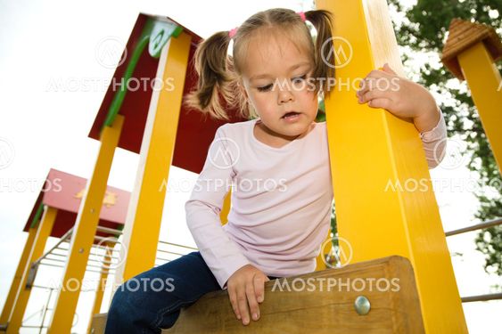 Little girl is playing in playground