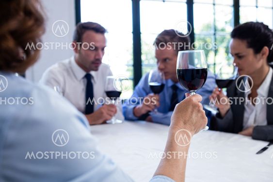 Group of businesspeople drinking wine glass during...