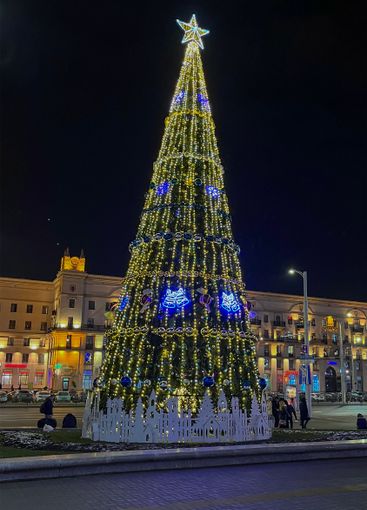 beautifully decorated Christmas tree on the square near...