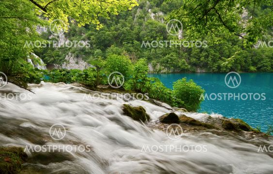 Flowing water and turquoise lake.