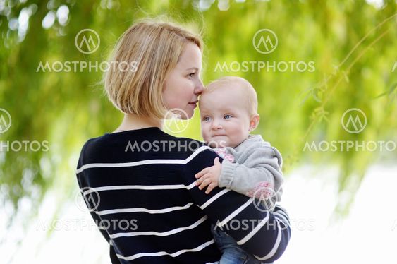 Young woman with her baby at the summer park