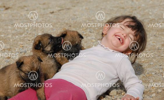 laughing girl and puppies