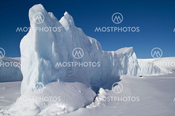 steep side of a large iceberg that is frozen in Antarctic...
