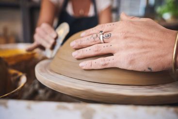 People, hands and pottery class in studio, working...