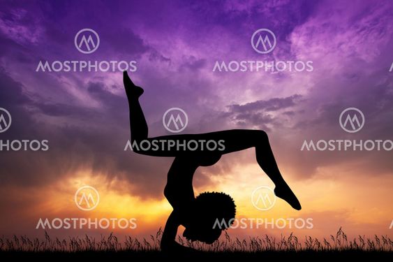 silhouette of girl yoga pose at sunset