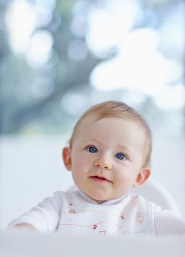 Baby, boy and curious in home chair, morning breakfast...
