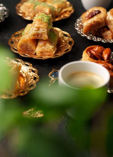 Traditional desserts and coffee served on ornate plates...