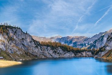 Sunny autumn alpine Tappenkarsee lake and rocky...