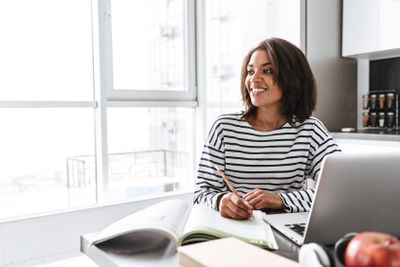 Smiling african woman sitting at the kitchen