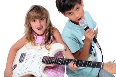 Little boy and girl playing musical instruments