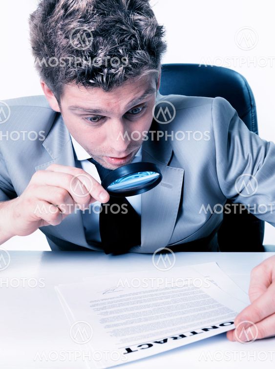 portrait of a handsome expressive man looking at a contract