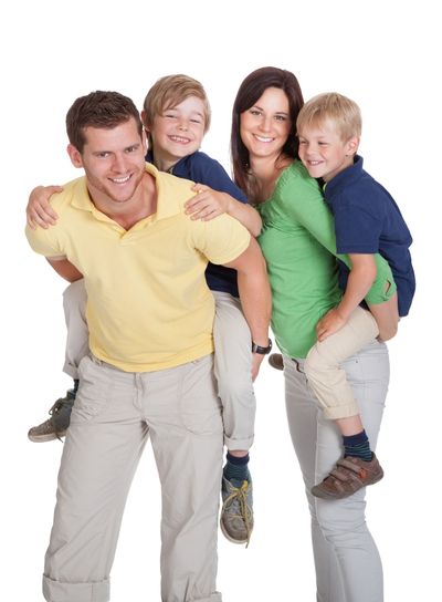 Happy Parents Piggybacking Children
