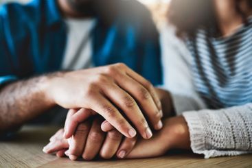 Empathy, couple and holding hands with comfort in home...