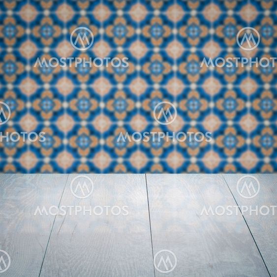 Wood table top and blur vintage ceramic tile pattern wall