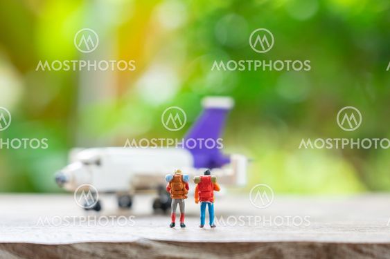 Miniature 2 people standing travel planner with Plane...