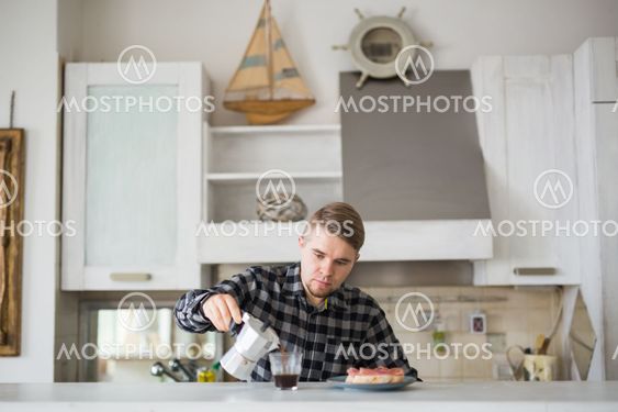Food, morning and people concept - Handsome man drinking...