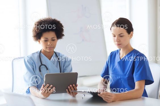 doctors with tablet pc meeting at hospital