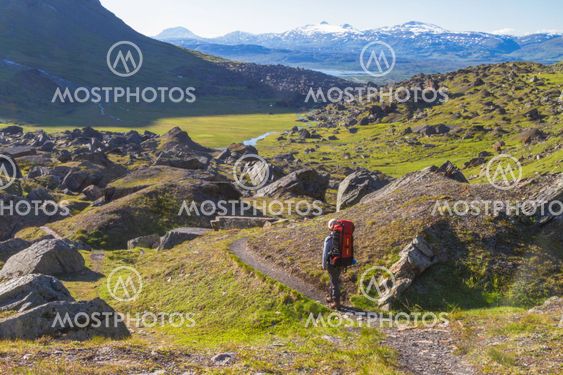 Woman hiking in mountains area in Sweden