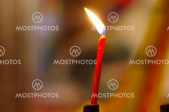 red burning, long candles in budist temple