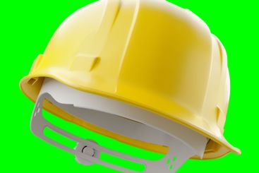 Yellow Construction Hard Hat Isolated on a Green Screen.