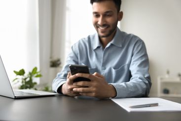 Young man use notebook cell in work at home office