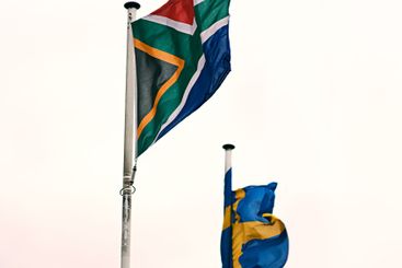 South African and Swedish flags in wind for pride,...