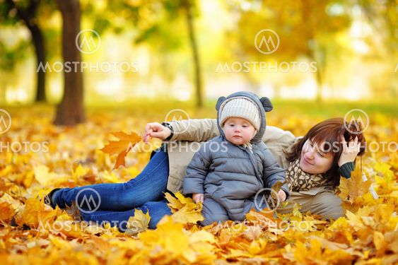Young mother with her baby in autumn