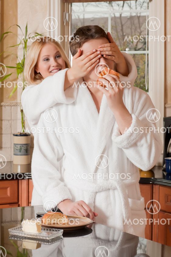 woman covering her husbands eyes