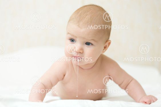 Cute baby raises head and chest, burping after eating