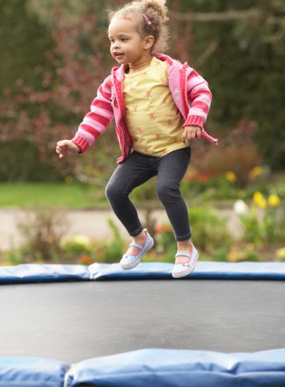 Girl Playing On Trampoline