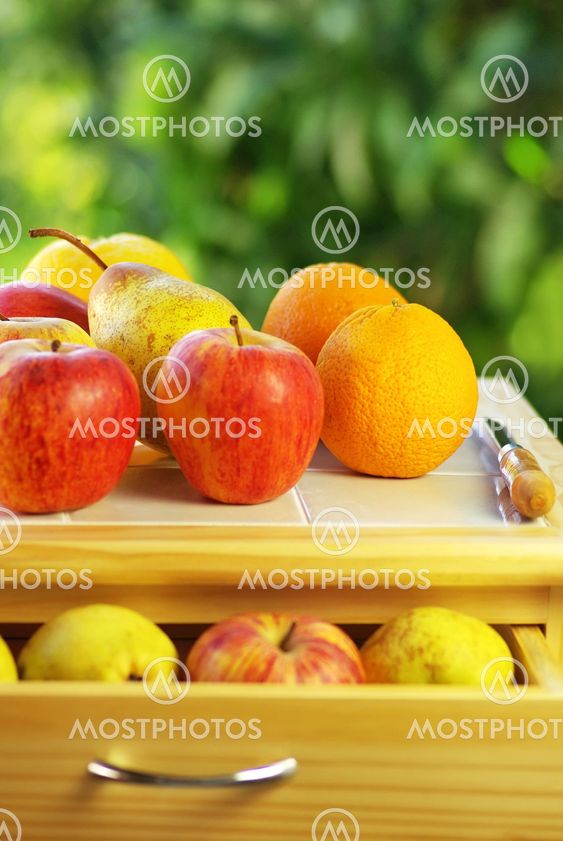 Fruits and knife on table.