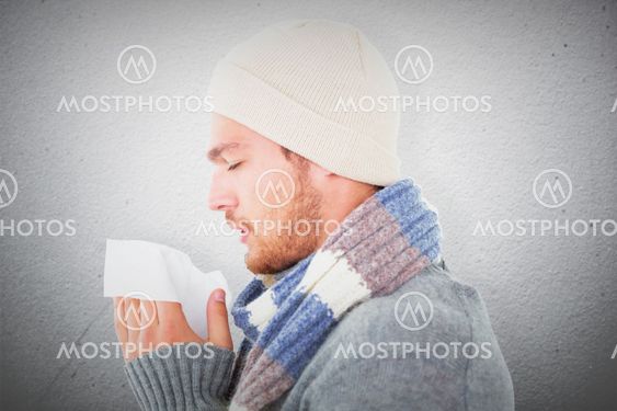 Composite image of handsome man in winter fashion blowing...