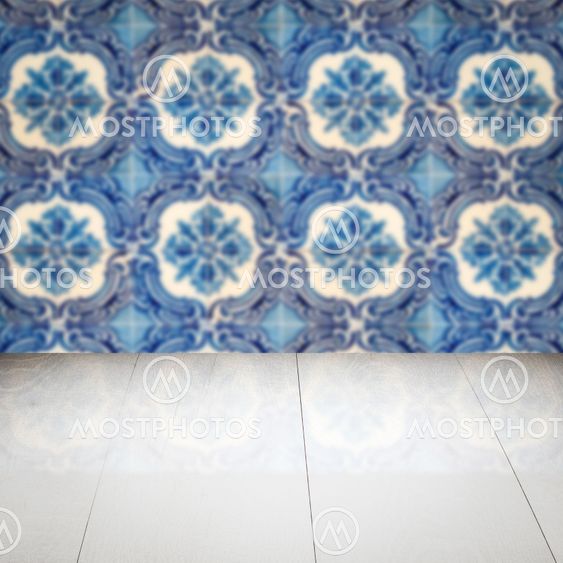 Wood table top and blur vintage ceramic tile pattern wall
