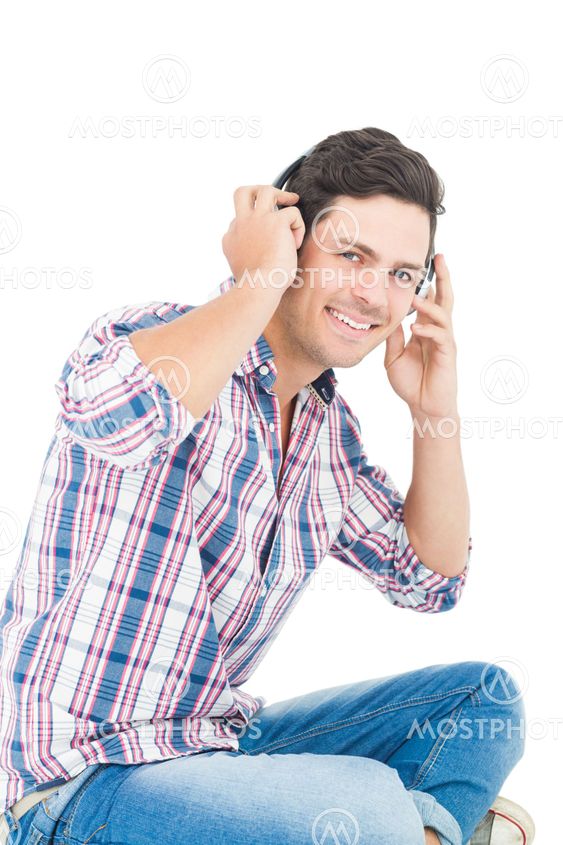 Man with headphones sitting on the floor